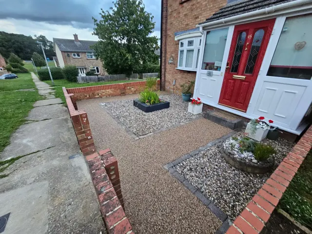 Gold resin front garden and path with gravel planting beds and brick edging