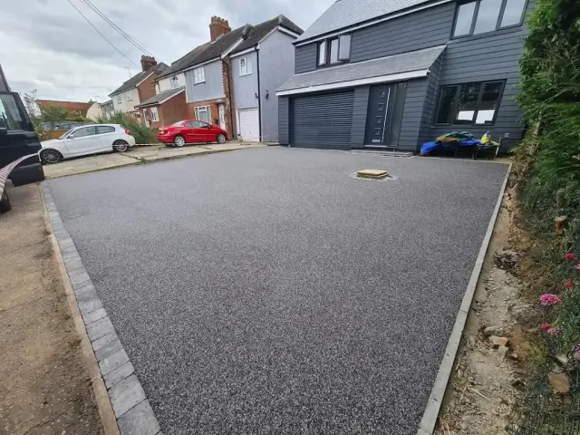 Charcoal resin bound driveway with a block paving border