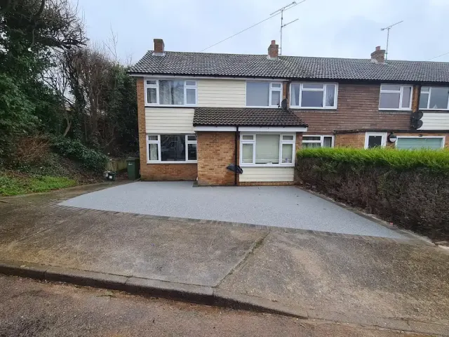 Pale grey resin driveway laid across a full house frontage