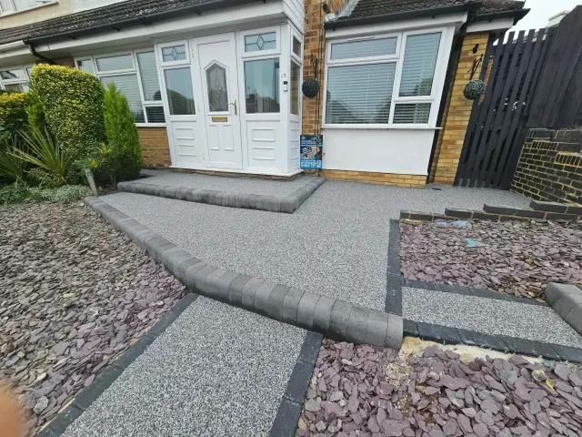 Silver resin driveway and path with charcoal block borders at a bungalow